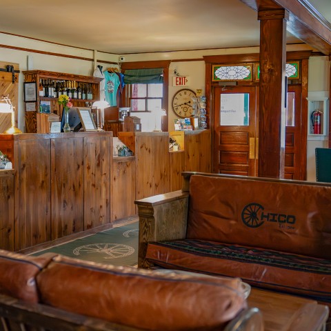 a room with a couch and a wood wall.
