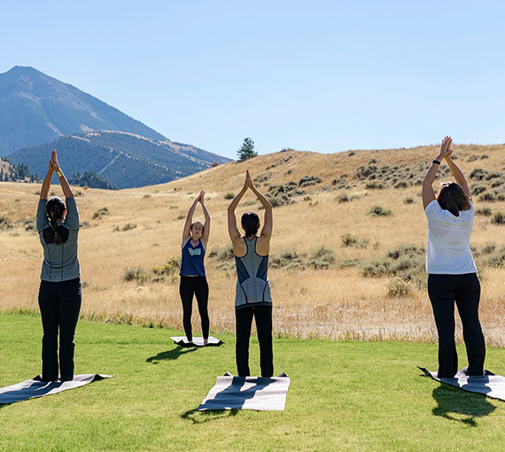 a group of people doing yoga outside