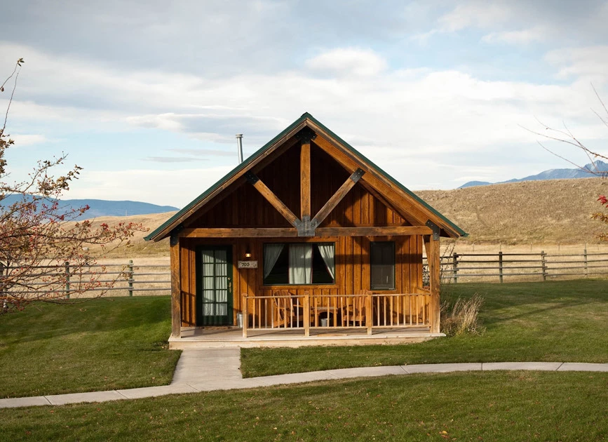 a wooden cabin in a field
