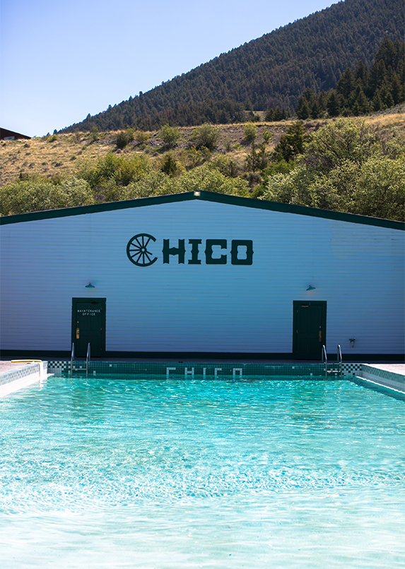 a swimming pool with a hill in the background