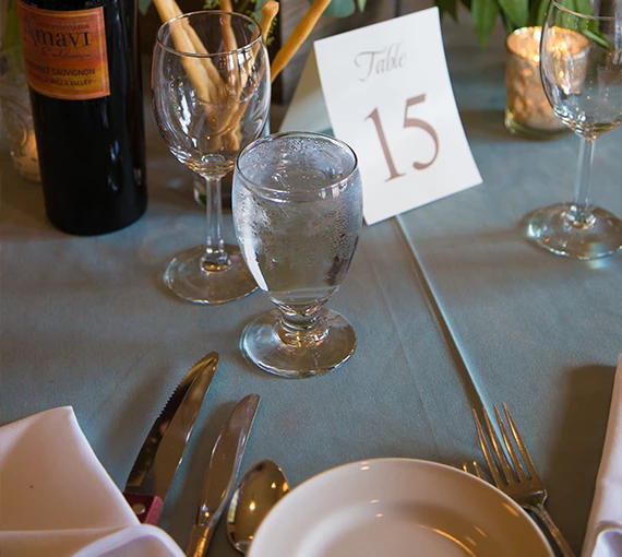 a table with wine glasses and a bottle of wine