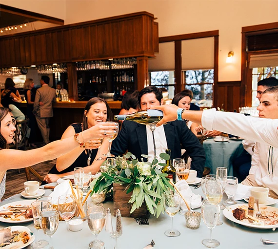 a group of people at a table with wine glasses