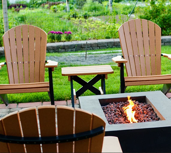 chairs and a fire pit in a backyard
