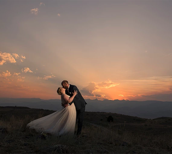 a man and woman kissing in a field