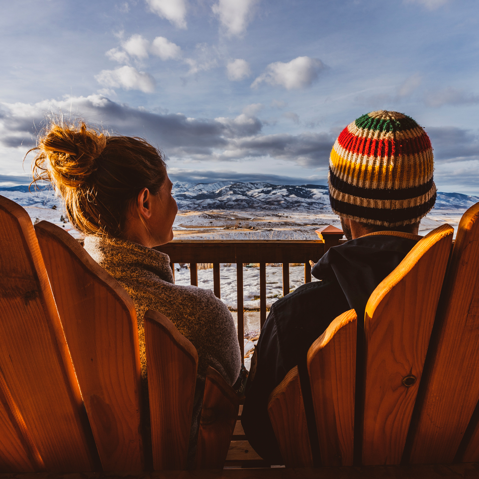 a man and woman sitting on a deck