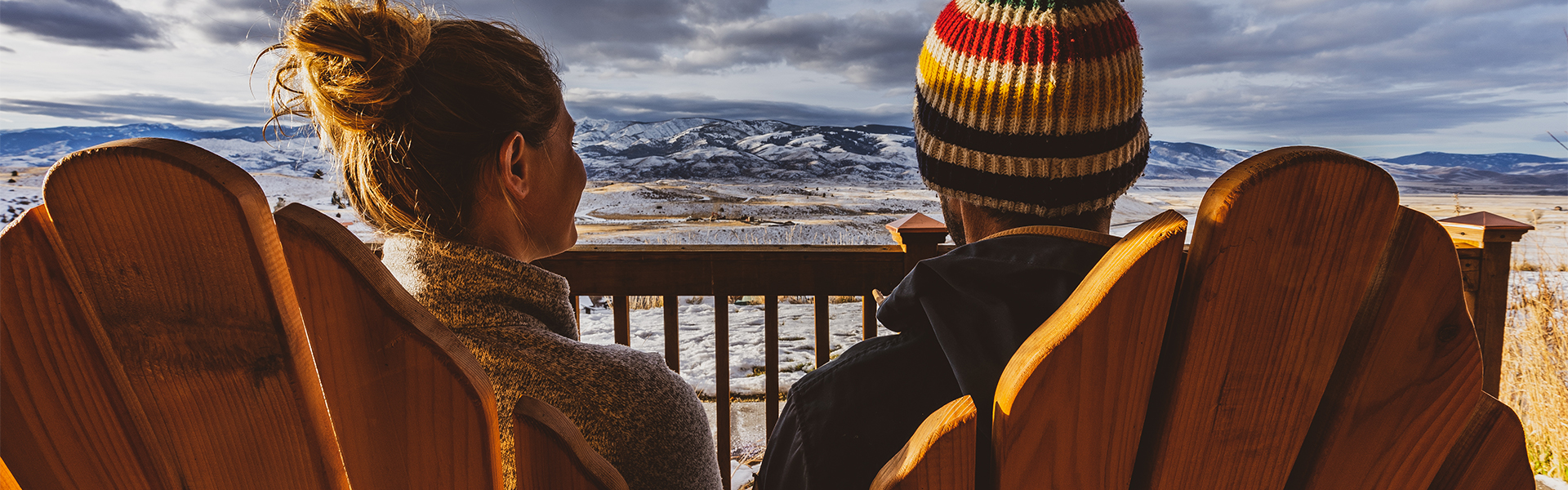 a man and woman looking at a snowy landscape