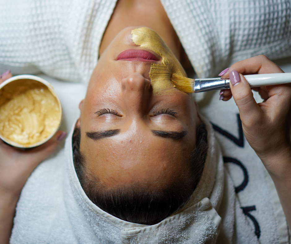 a woman lying down with a brush on her face