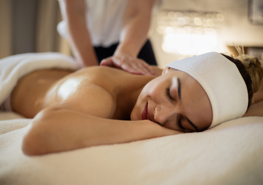 a woman lying down on a massage table