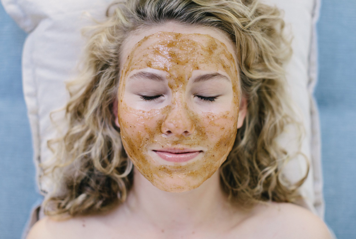 a woman with orange scrub on her face