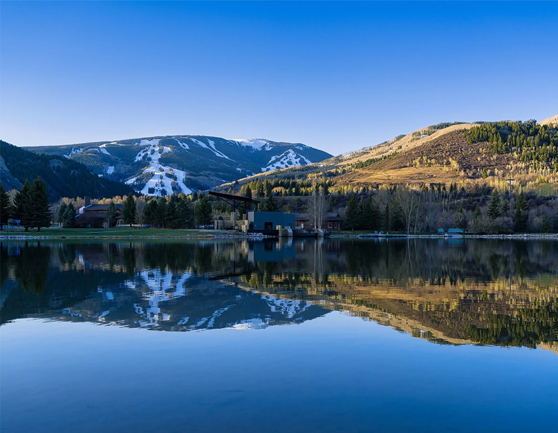 a lake with mountains in the background