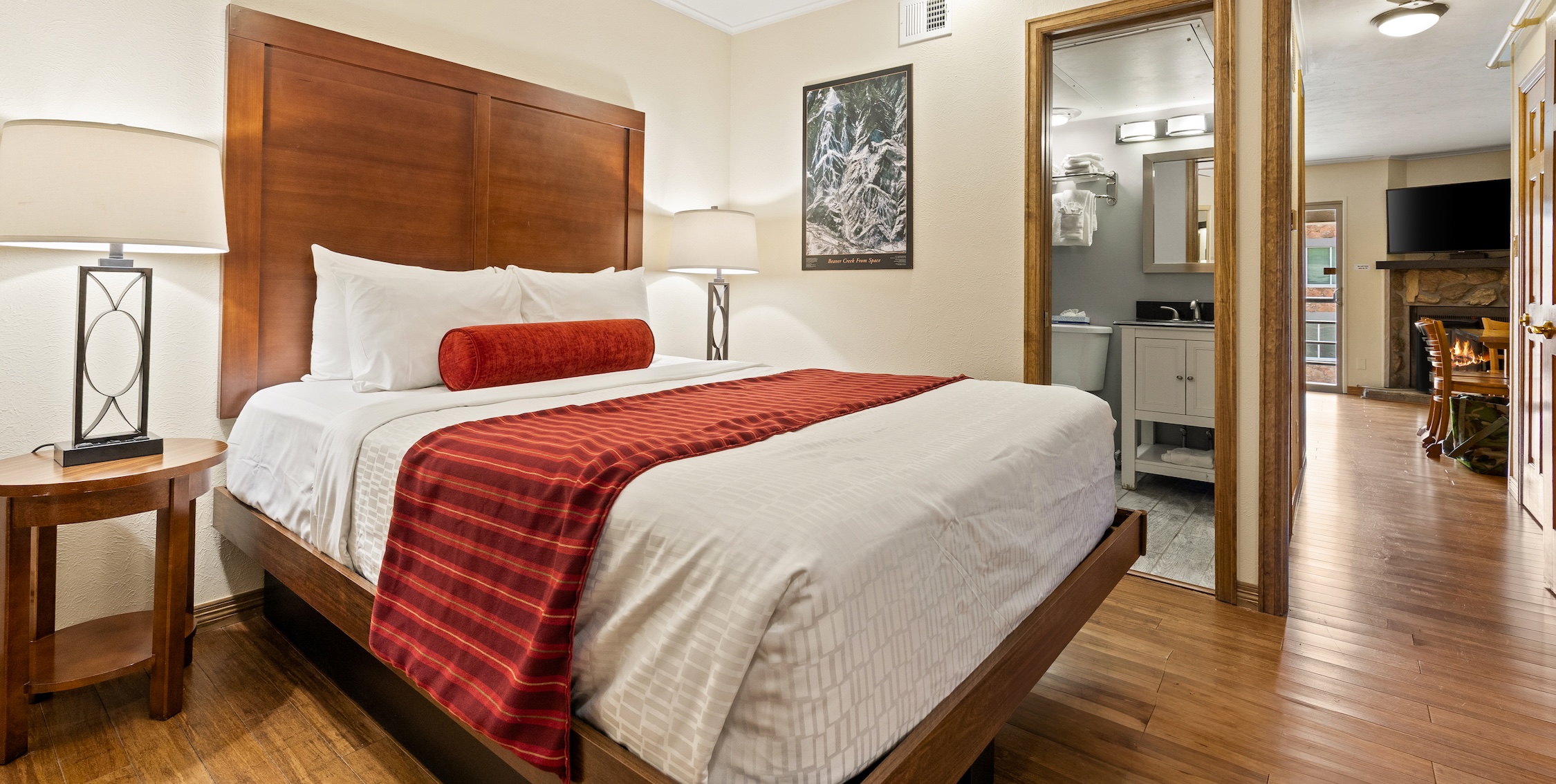 a bed with a wood headboard and a lamp