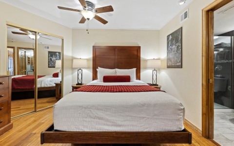a bed with a fan and a mirror