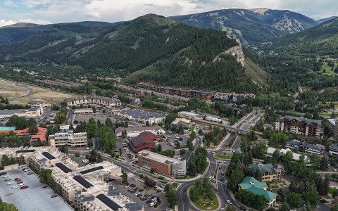 a city with many roads and buildings in the mountains