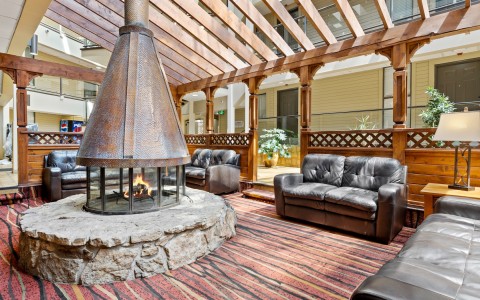 a room with a fireplace and couches
