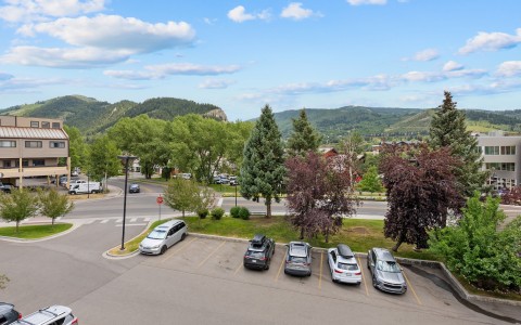 a parking lot with cars and trees