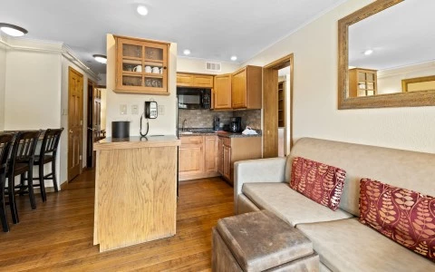 a living room with a couch and kitchen