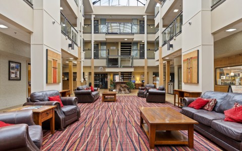 a room with a red carpet and chairs
