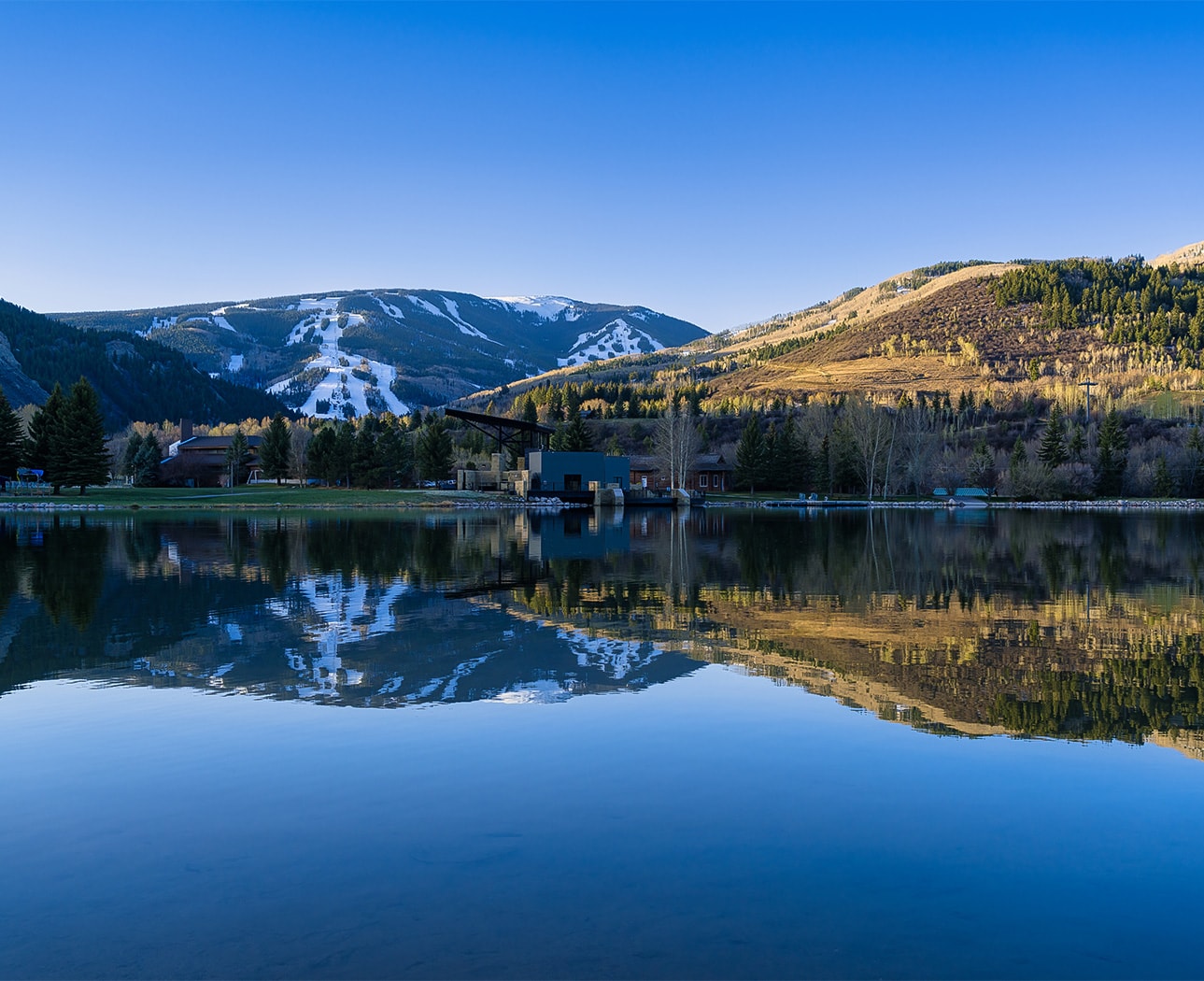 a lake with mountains in the background