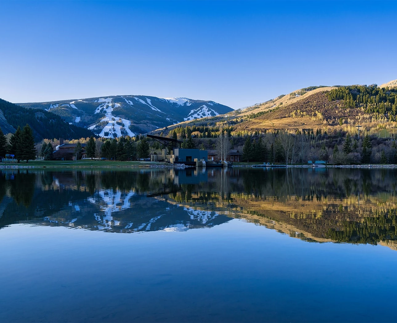a lake with mountains in the background