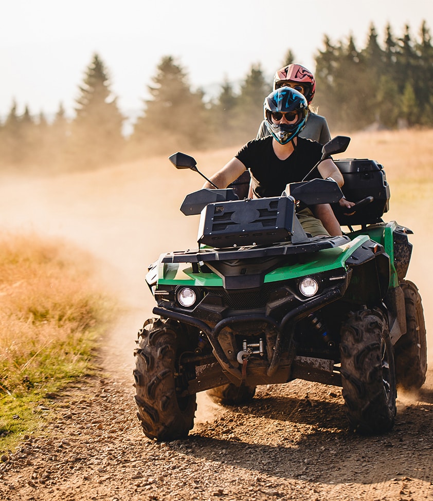 two people riding a quad