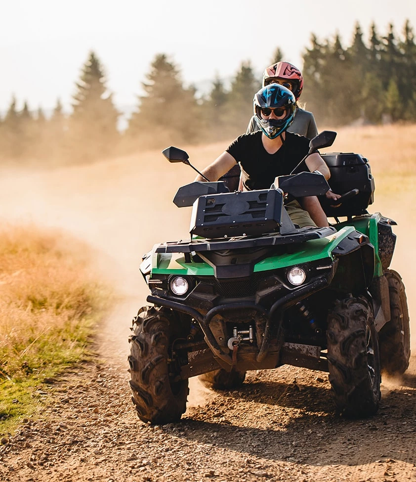 two people riding a quad