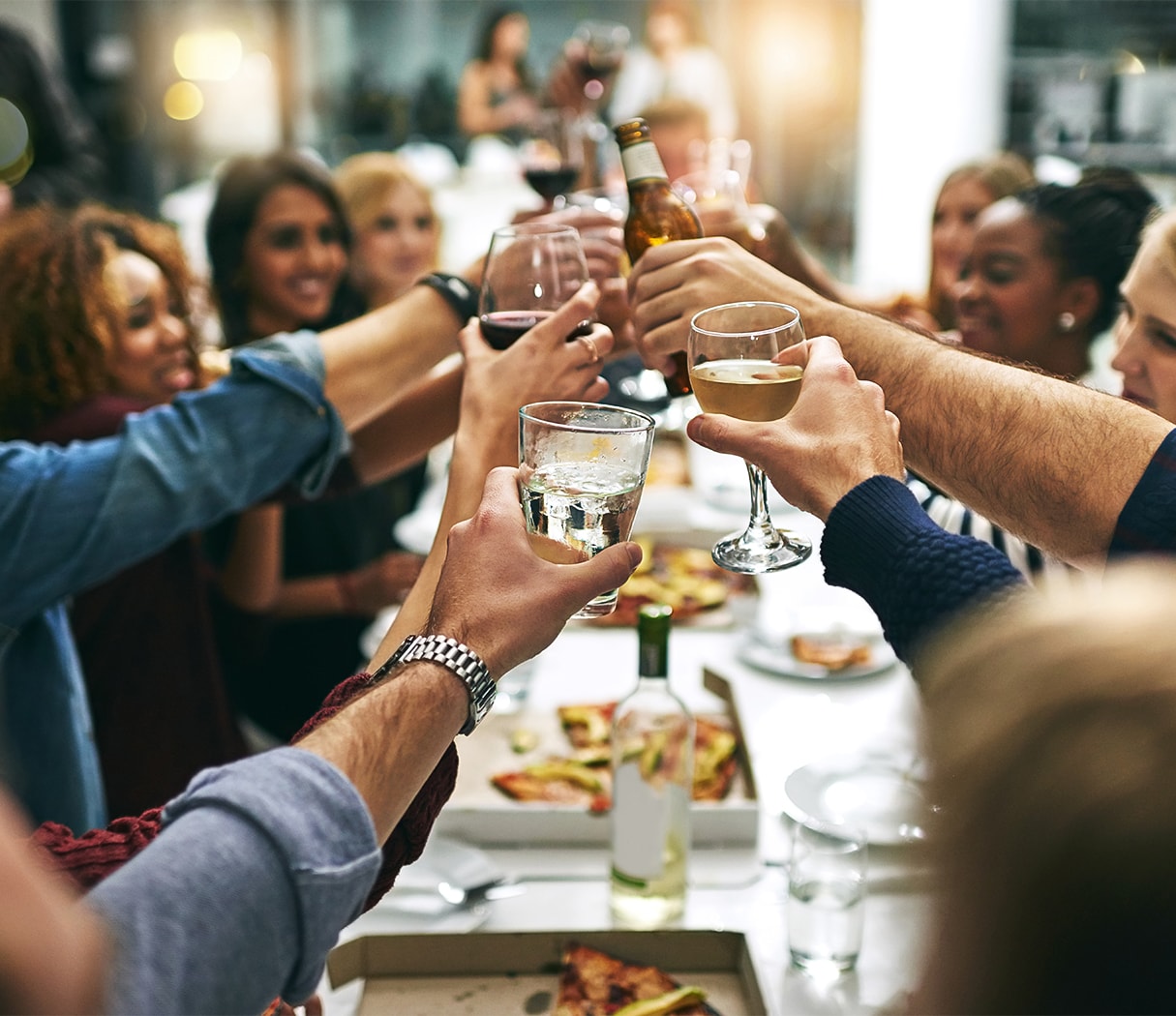 a group of people holding glasses of beer