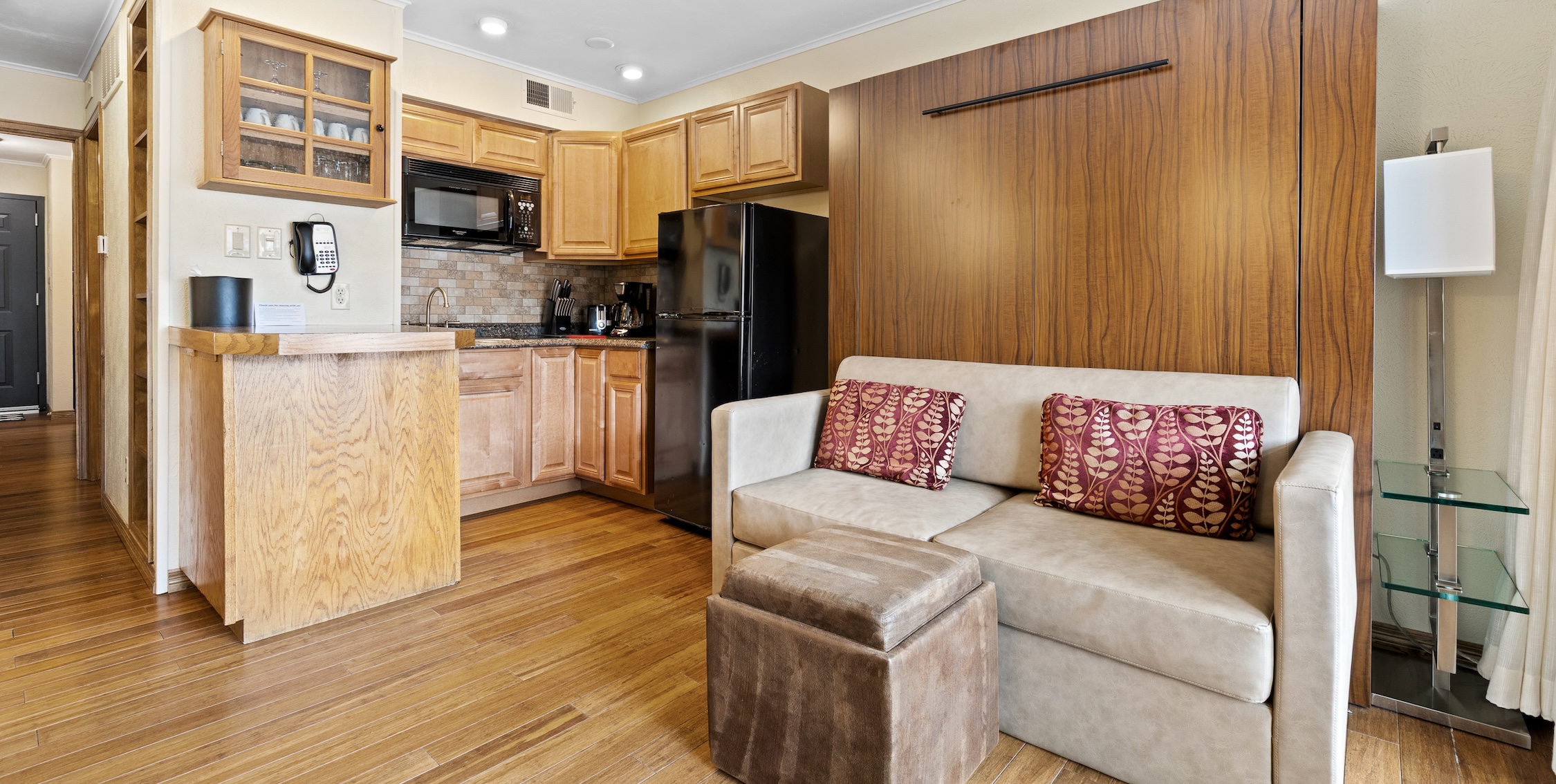 a living room with a couch and a refrigerator