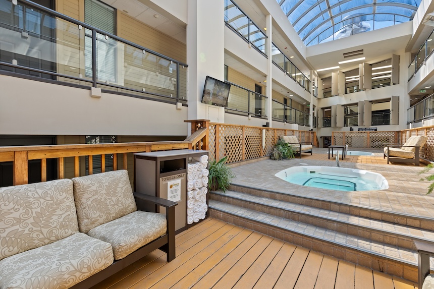 a patio with a hot tub and a couch
