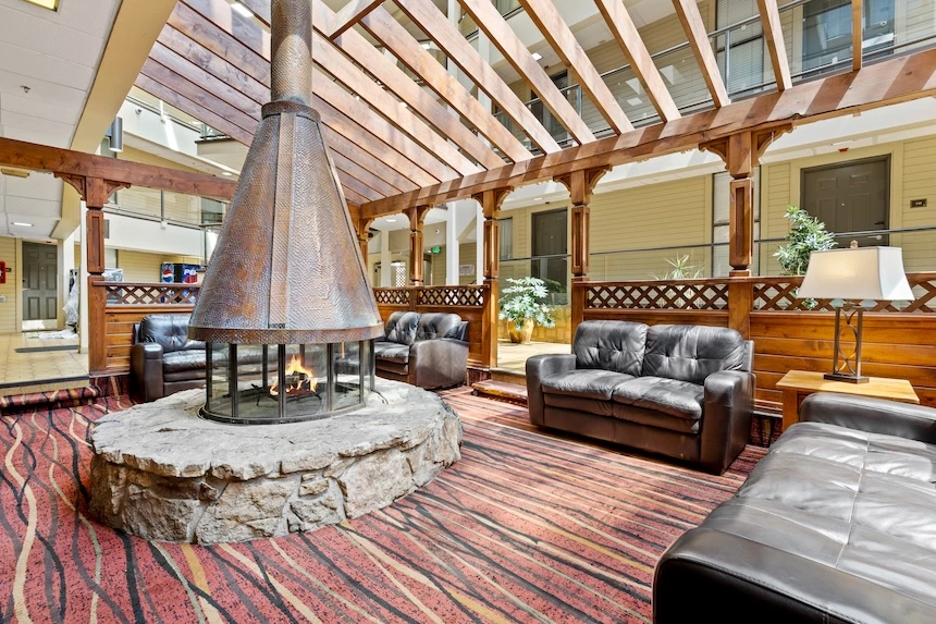 a room with a fireplace and couches