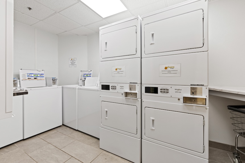 a laundry room with white appliances