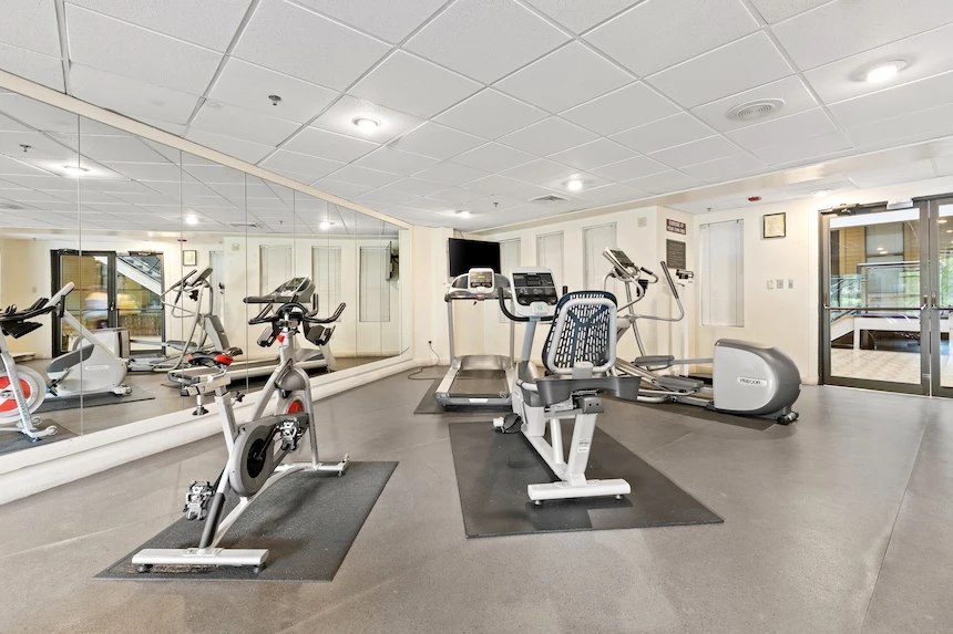 a room with exercise bikes and mirrors
