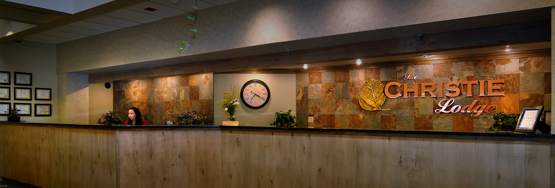 a reception desk with a clock and plants