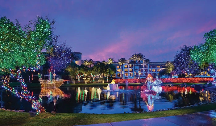 many lit decorations on a lake at dusk