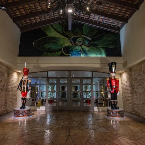a large room with a large glass door and a large green flower above it