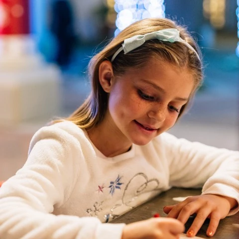 a girl sitting at a table