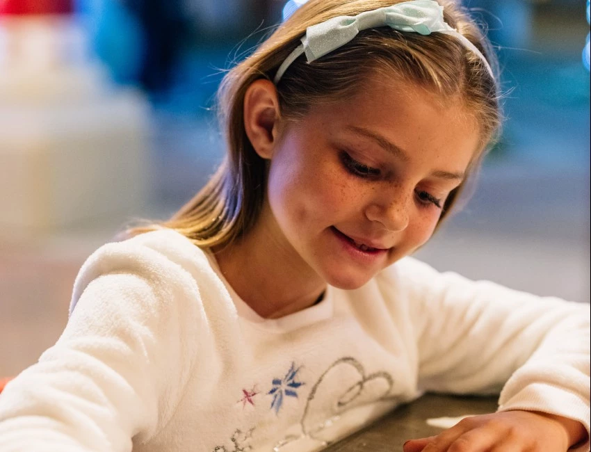 a girl sitting at a table