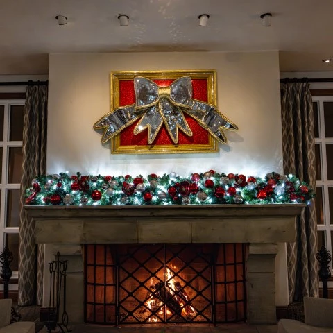 a fireplace with a large bow on top