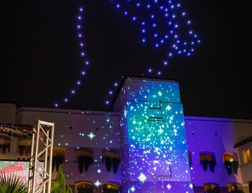 a building with lights in the sky smores land