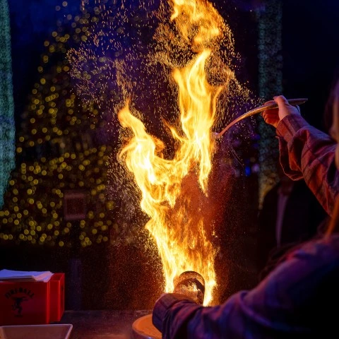 a person lighting a fire