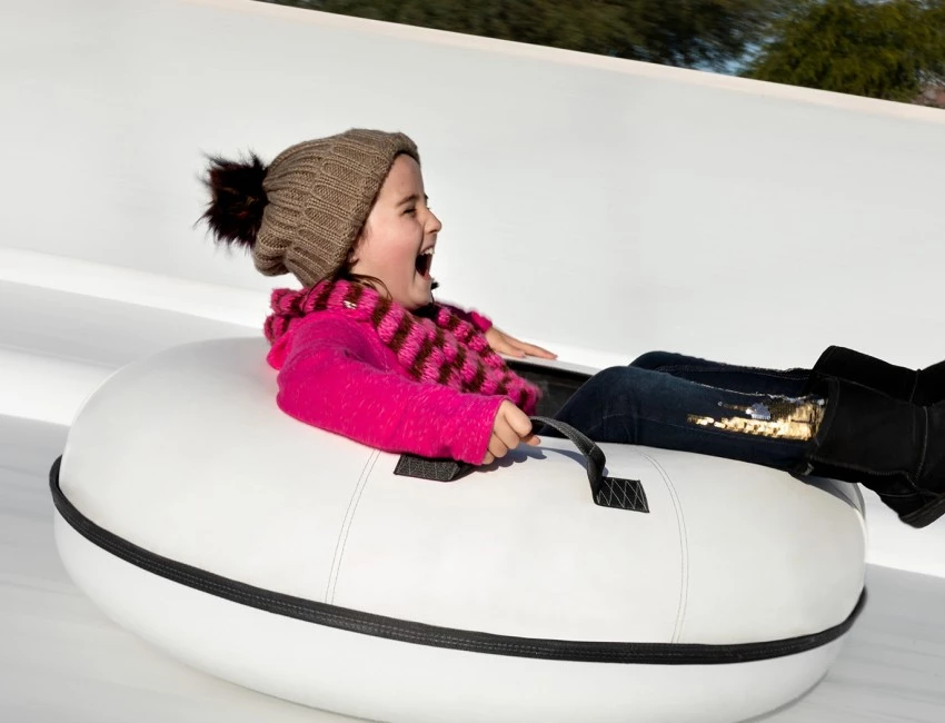 a girl smiling while sledding