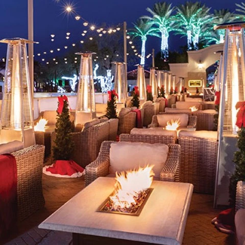 a large outdoor area with places to sit and relax with fire pits