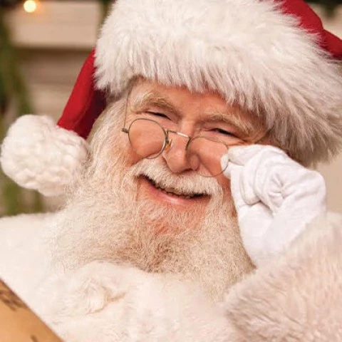 smiling santa holding his glasses