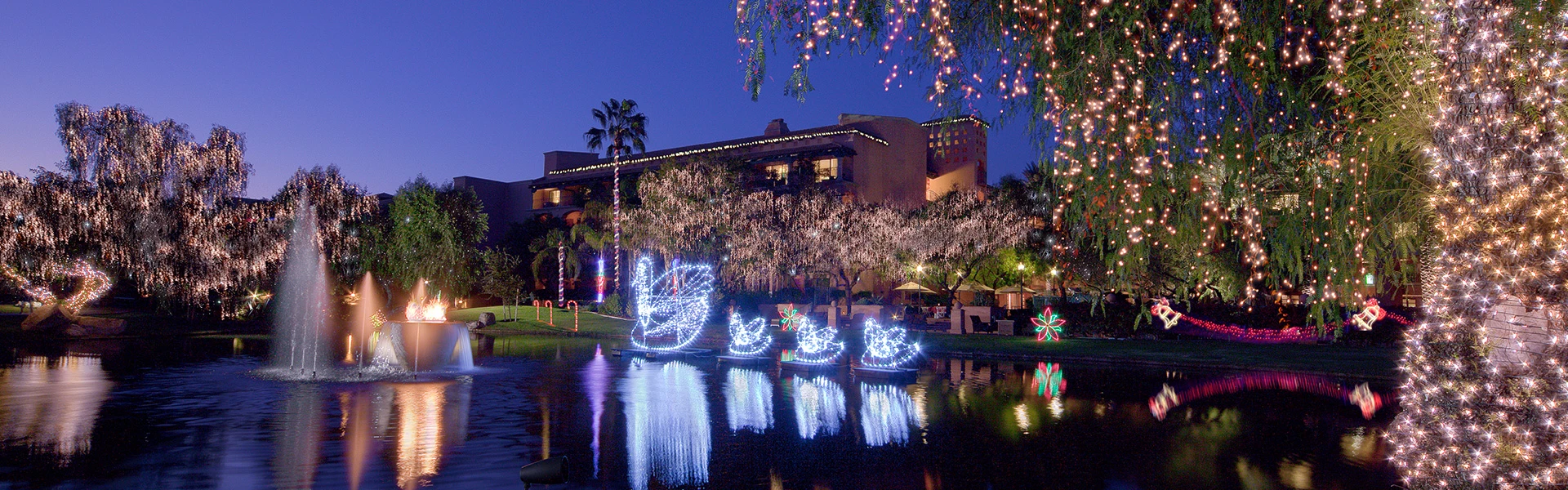 a large lake with lit decorations on it and next to it