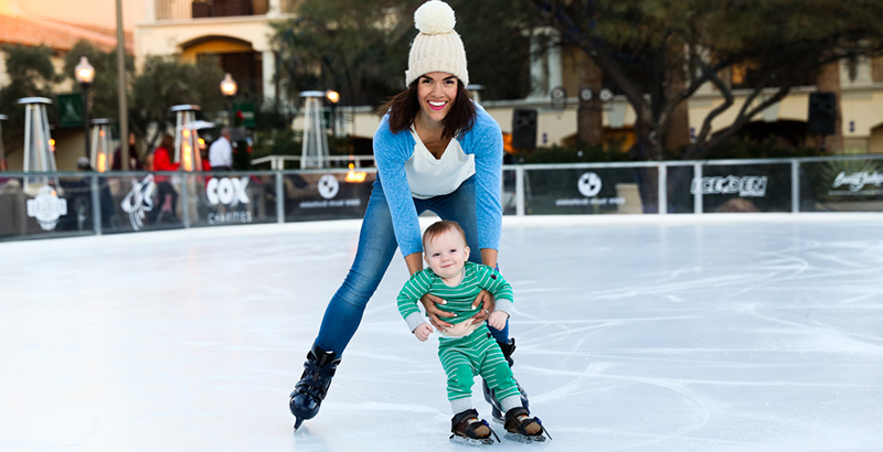a woman ice skating with her young child
