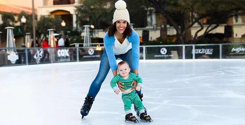 a woman ice skating with her young child Preview