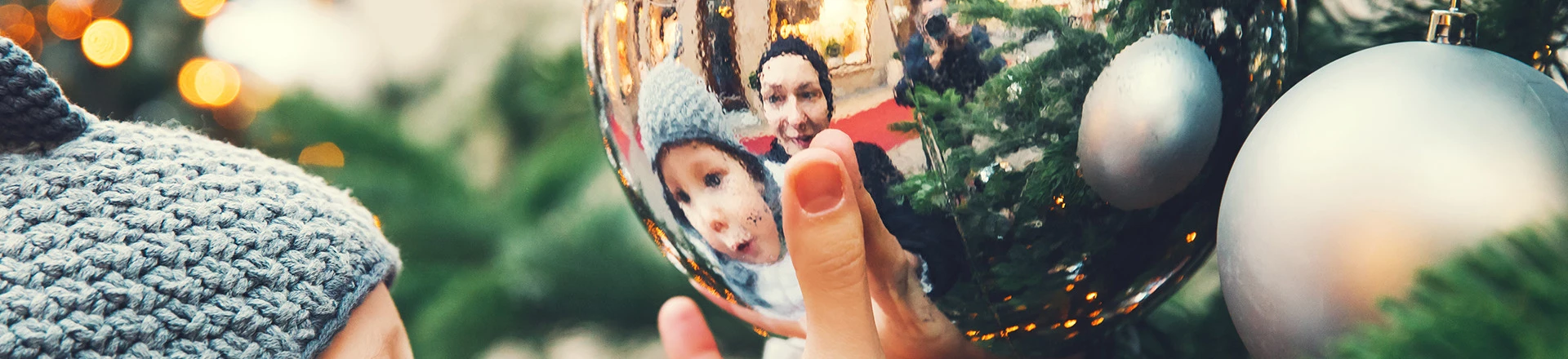 view of a kid seeing himself on a christmas ball
