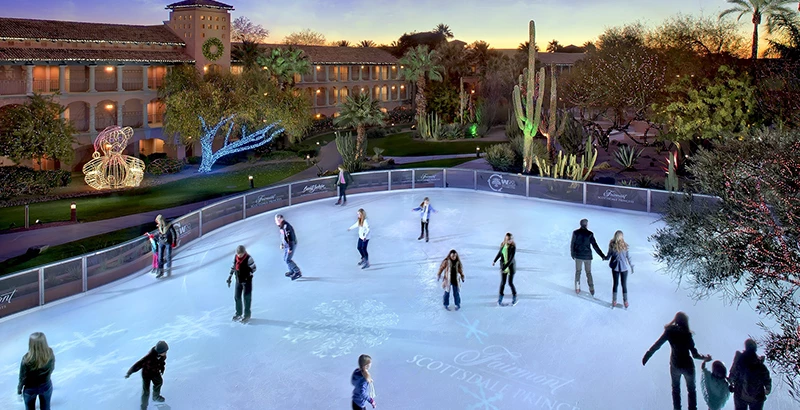 people skating on the outdoor ice rink at sunset Preview