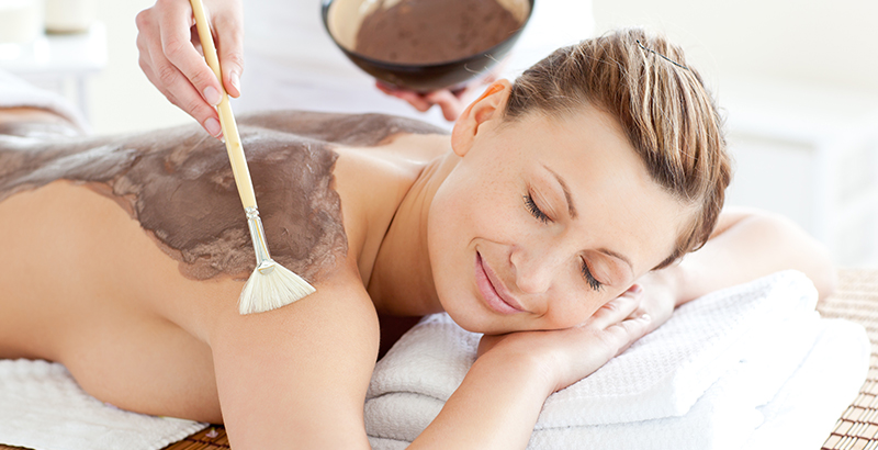 a woman at the spa getting a mask on her back