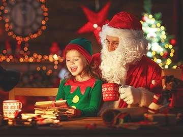 a child sitting next to santa claus