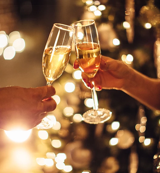 a group of hands holding wine glasses